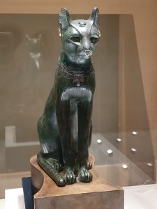 An Egyptian statue of a cat, symbolizing metaphysical and fantasy content